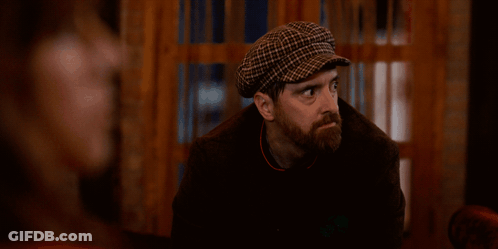 Bearded Man In Plaid Hat Looking At Camera GIF
