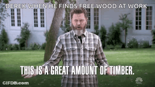 Bearded Man In Plaid Shirt Standing In Field GIF