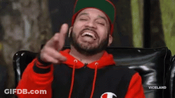 Bearded Man In Red Hoodie And Green Hat Pointing GIF