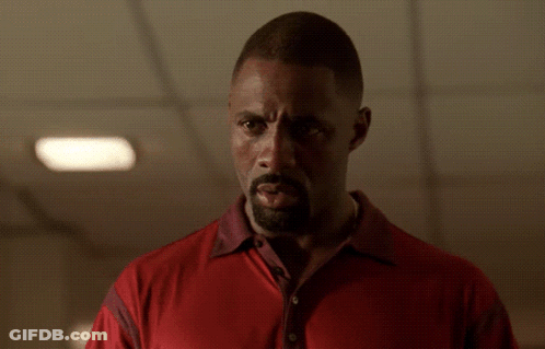 Bearded Man In Red Shirt Looking At Camera GIF