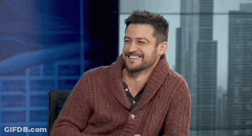 Bearded Man In Red Sweater Smiling In Chair GIF