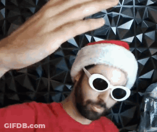Bearded Man In Santa Hat And Sunglasses Taking Selfie GIF