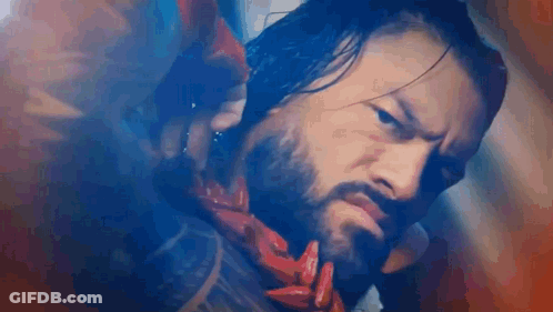 Bearded Man In Scarf Holding Red Object GIF