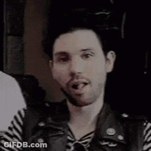 Bearded Man In Striped Shirt And Leather Vest Smiling GIF