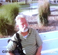 Bearded Man In Striped Shirt Carrying Bag GIF