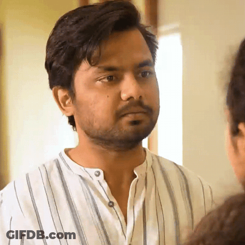 Bearded Man In Striped Shirt Looking At Another Man GIF