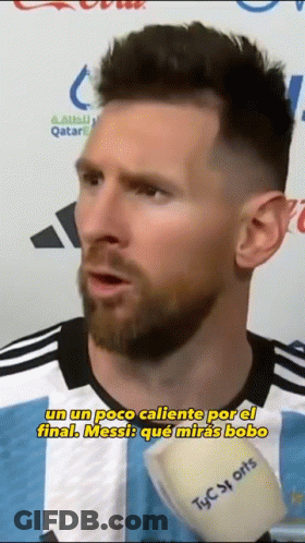 Bearded Man In Striped Shirt Talking Into Microphone GIF