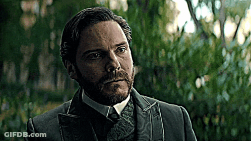 Bearded Man In Suit And Tie In Front Of Trees GIF