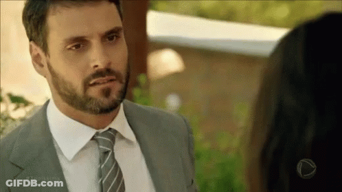 Bearded Man In Suit And Tie Looking At Woman GIF