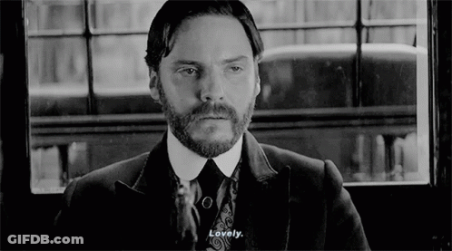 Bearded Man In Suit And Tie Looking Out Window GIF