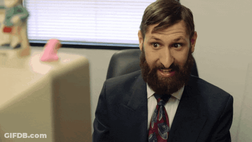 Bearded Man In Suit And Tie Making Funny Face GIF