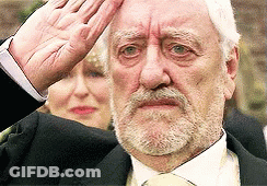 Bearded Man In Suit And Tie Saluting GIF