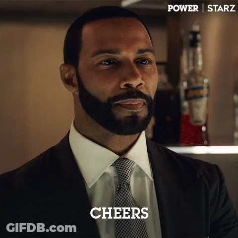 Bearded Man In Suit And Tie Saying Cheers GIF