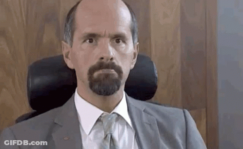 Bearded Man In Suit And Tie Sitting GIF