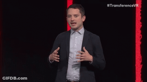 Bearded Man In Suit Speaking Into Microphone GIF