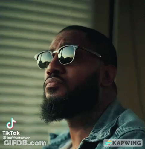 Bearded Man In Sunglasses And Denim Jacket Looking Up GIF