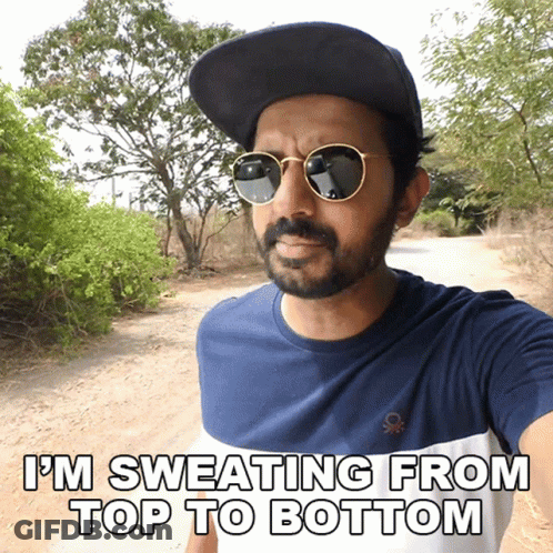 Bearded Man In Sunglasses And Hat Sweating GIF