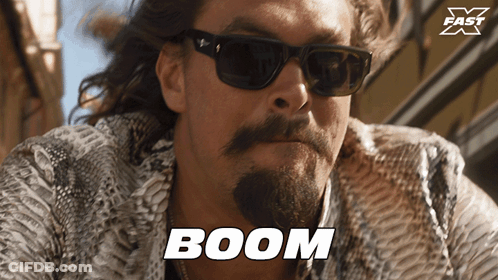Bearded Man In Sunglasses And Snakeskin Coat Says Boom GIF