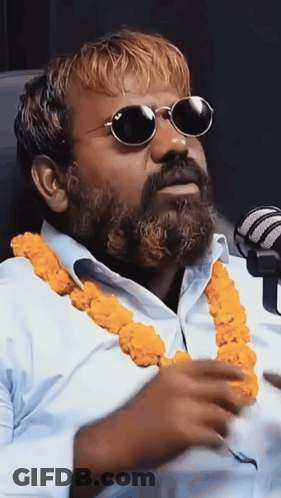 Bearded Man In Sunglasses At Microphone GIF
