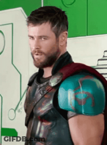 Bearded Man In Superhero Costume Looking At Camera GIF