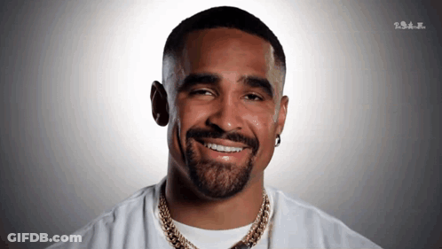 Bearded Man In White Shirt And Gold Chains Smiling GIF