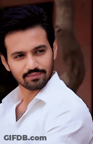 Bearded Man In White Shirt Looking At Camera GIF