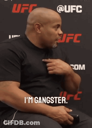 Bearded Man In White Shirt Making Funny Face With Hand GIF