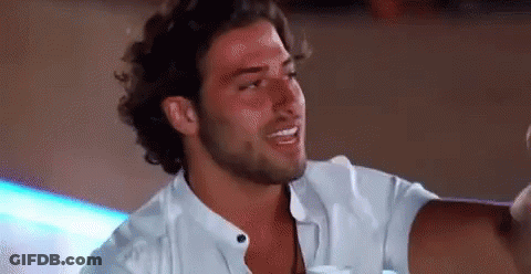 Bearded Man In White Shirt Sitting At Table GIF