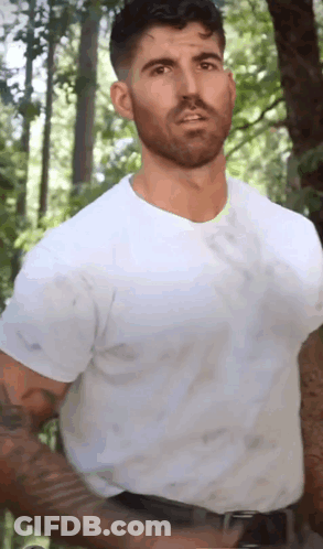 Bearded Man In White T-Shirt In Woods GIF
