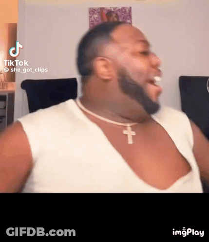 Bearded Man In White Tank Top And Cross Necklace GIF