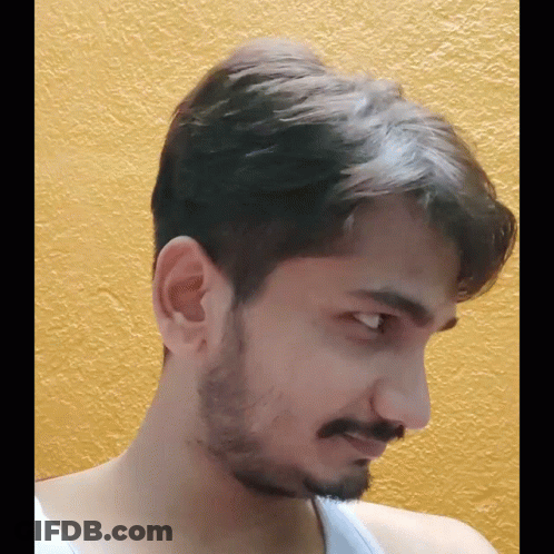 Bearded Man In White Tank Top Looking At Camera GIF