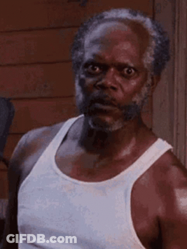 Bearded Man In White Tank Top Making Funny Face GIF