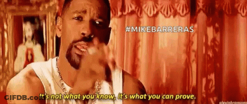 Bearded Man In White Tank Top Talking By Red Curtain GIF