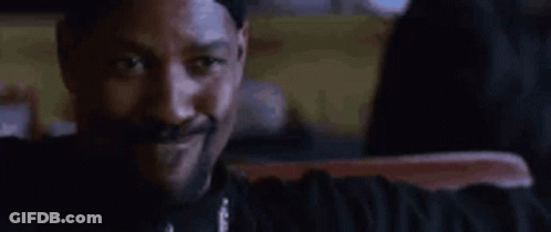 Bearded Man In White Tank Top Talks Before Red Curtain GIF