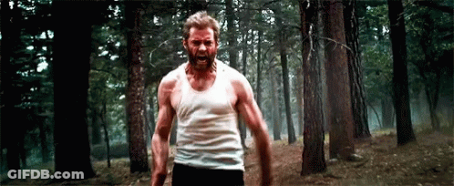 Bearded Man In White Tank Top Walking Through Forest GIF