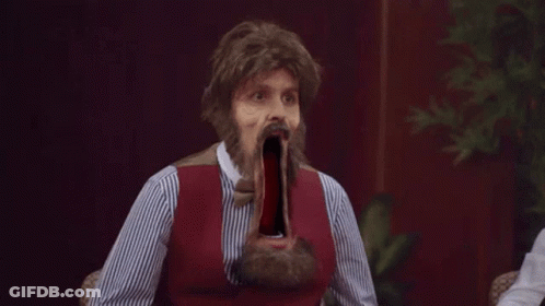 Bearded Man In Wig With Mouth Wide Open At Table GIF