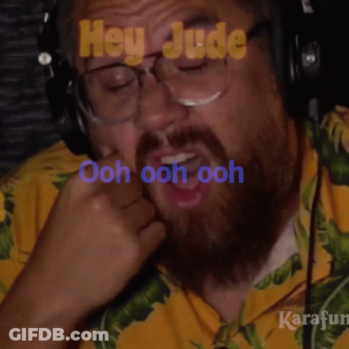 Bearded Man In Yellow Shirt And Headphones Saying Ooh GIF