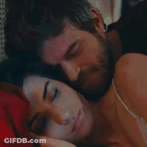 Bearded Man Kissing Sleeping Woman On Forehead GIF