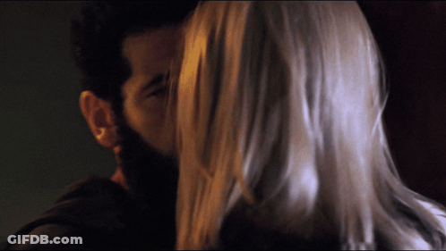 Bearded Man Kissing Woman With Long Hair GIF