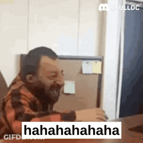 Bearded Man Laughing At Skulldc Computer Screen GIF