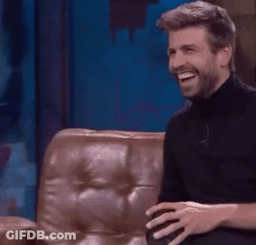 Bearded Man Laughing On Couch GIF