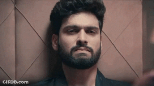Bearded Man Laying Down Looking At Camera GIF