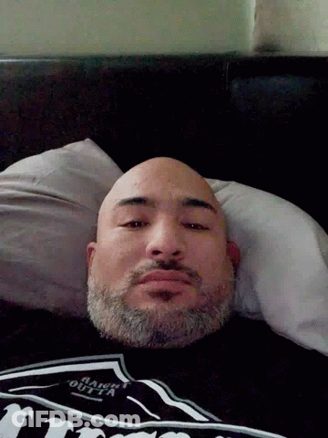 Bearded Man Laying In Bed In Jack Daniels Shirt GIF