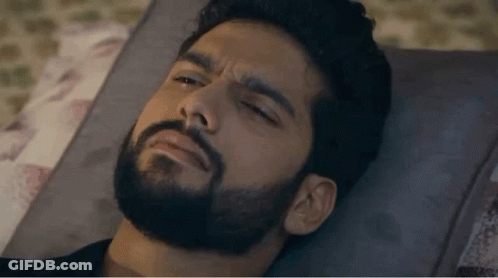 Bearded Man Laying On Bed Eyes Closed GIF