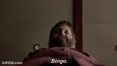 Bearded Man Laying On Bed Says Bingo GIF