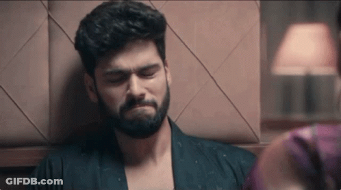 Bearded Man Leaning On Wall Woman Watching GIF