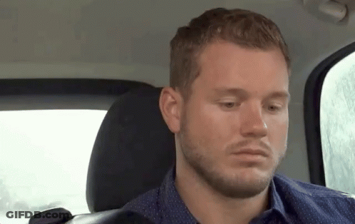 Bearded Man Looking At Camera From Back Seat GIF