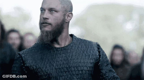 Bearded Man Looking At Camera In Crowd GIF