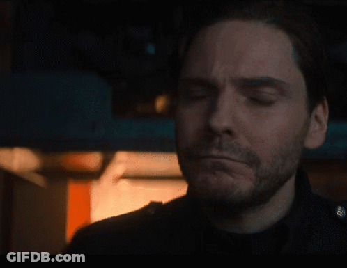 Bearded Man Looking At Camera In Dark Room GIF