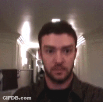 Bearded Man Looking At Camera In Hallway GIF